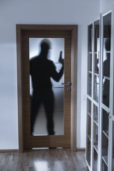 Shadow of burglar behind doors — Stock Photo, Image