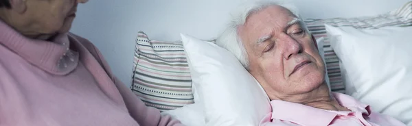 Older woman and sleeping husband — Stock Photo, Image