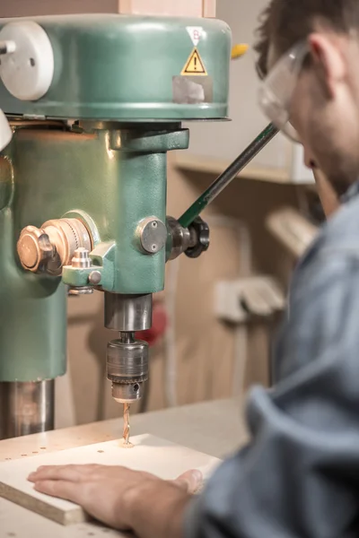 Carpentry drill operated by worker — Stock Photo, Image