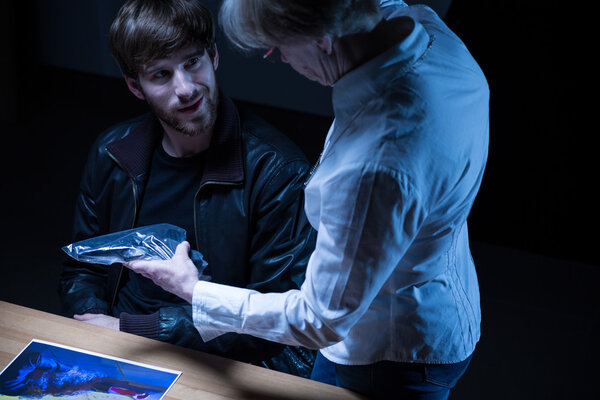 Police officer showing gun 