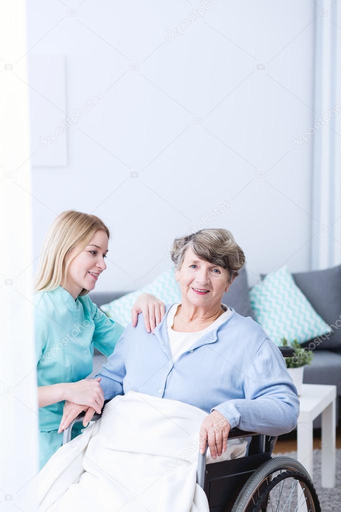 Caregiver supporting senior lady