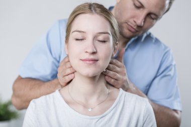 Woman havinh her neck massaged clipart