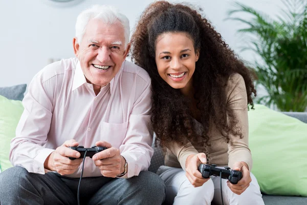 Modern senior playing on console — Stock Photo, Image