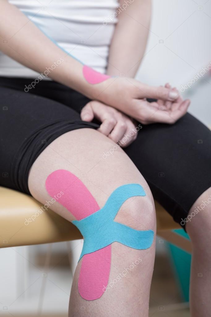 Knee taped with kinesio tape Stock Photo by ©photographee.eu 98352902