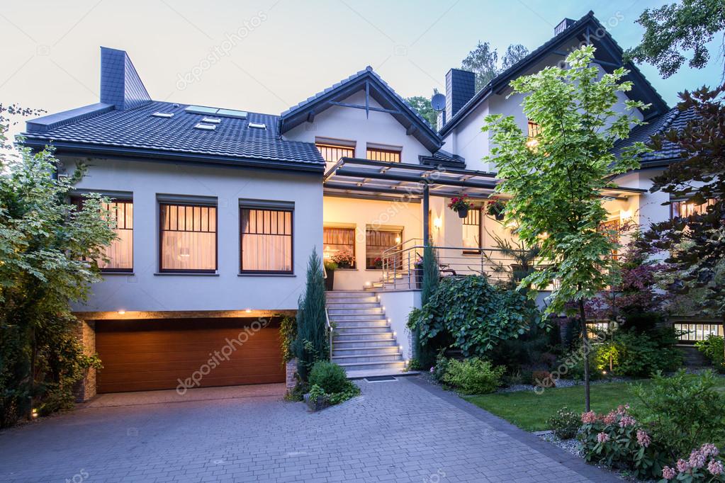 Big detached house with lights on — Stock Photo © photographee.eu 98859810