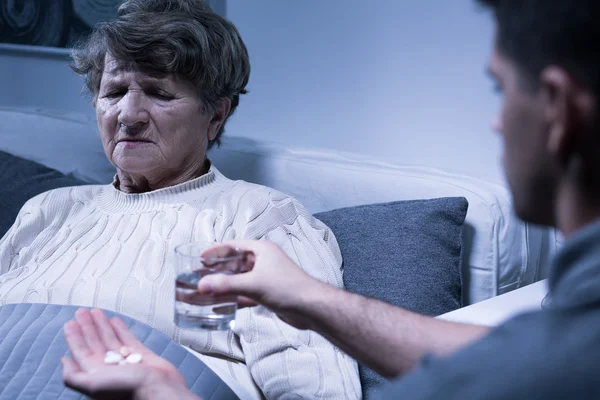 Grandson and sick grandmother — Stock Photo, Image