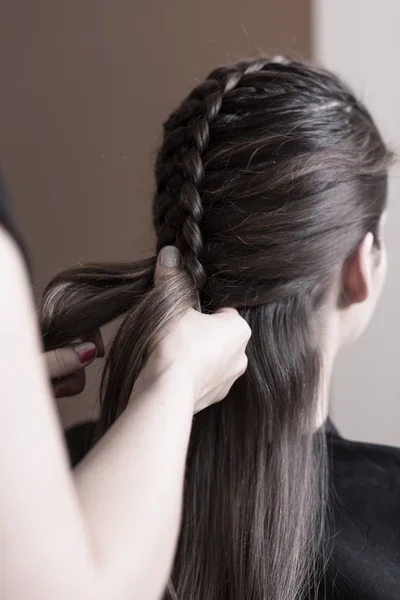Hairdresser making a dutch braid — Stock Photo, Image
