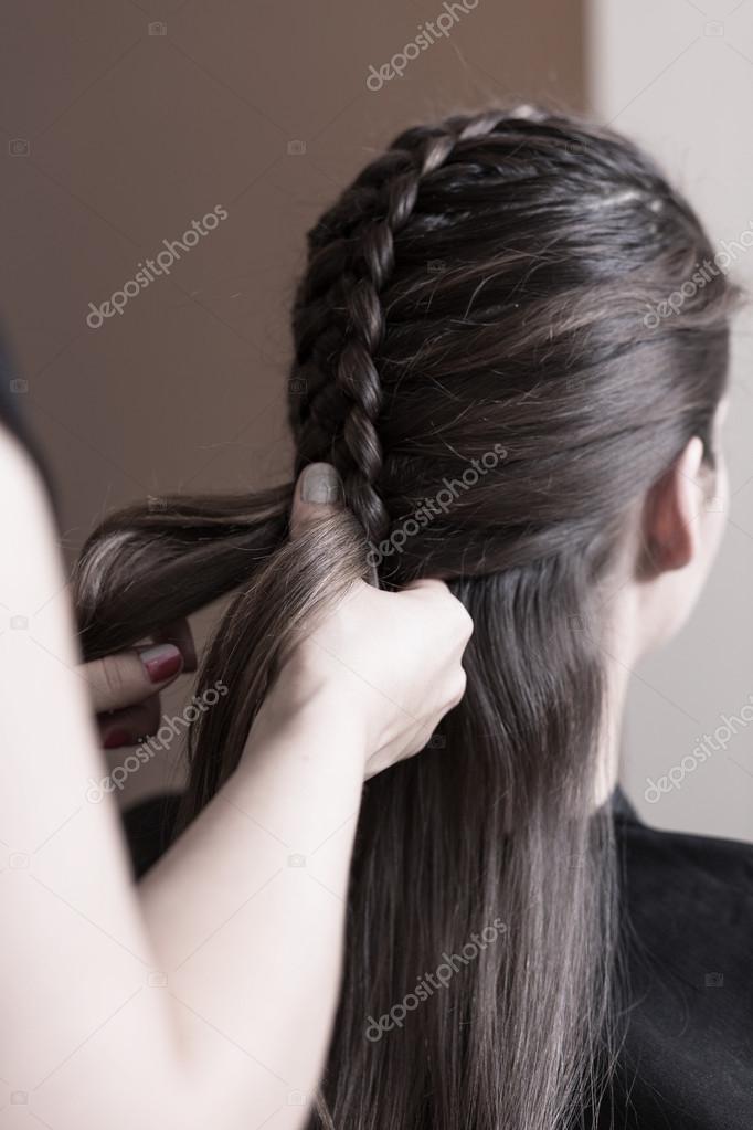 Hairdresser making a dutch braid