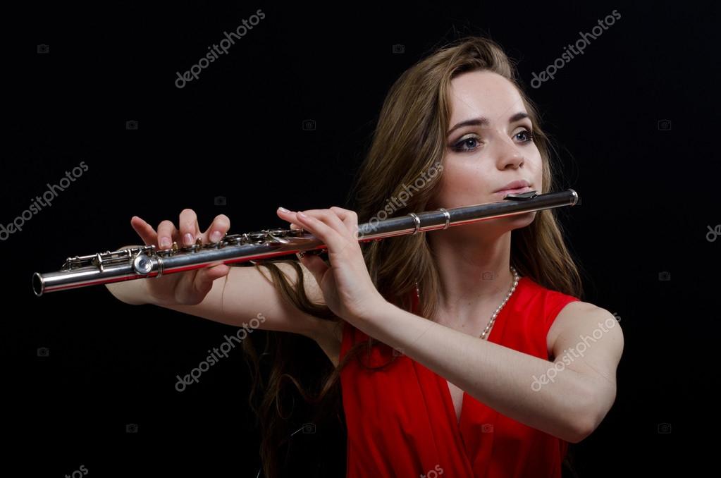 девушка держит дудочку в студии. австралийка сыграла на флейте своей. ксения куэльяр флейта. девушка играет на флейте. человек с флейтой.