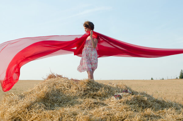 girl in field with cloth