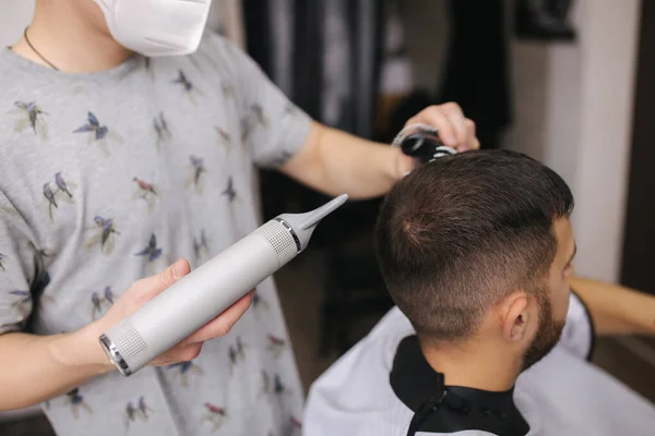 Κομμωτήριο χρήση στεγνωτήρα μαλλιών για την κατασκευή ενός hairdress, κουρέας και πελάτης με μάσκα προσώπου — Φωτογραφία Αρχείου