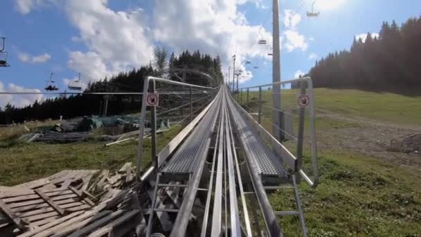 Clombing Rodelbahn or Alpine Coaster first person view. Sunny summer day. POV — Stock Video