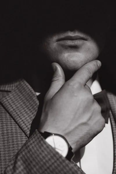 Close up brutal portrait of handsome groom. Black and white photo of man put his hand on chin — Stock Photo, Image