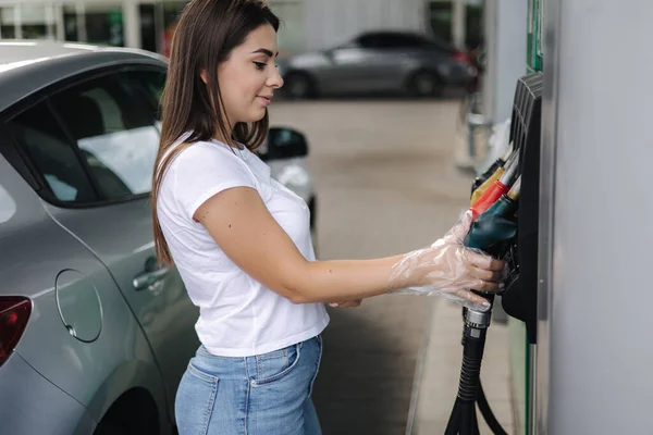 Femme se prépare pour le ravitaillement à la station-service. Femme remplissage à la main benzine essence carburant dans la voiture. Concept des prix de l'essence — Photo