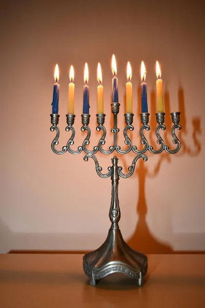 A traditional candlestick with lit candles for celebrating the Jewish holy holiday of Hanukkah.