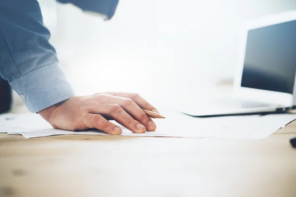 Businessman handing pencil — Stock Photo, Image