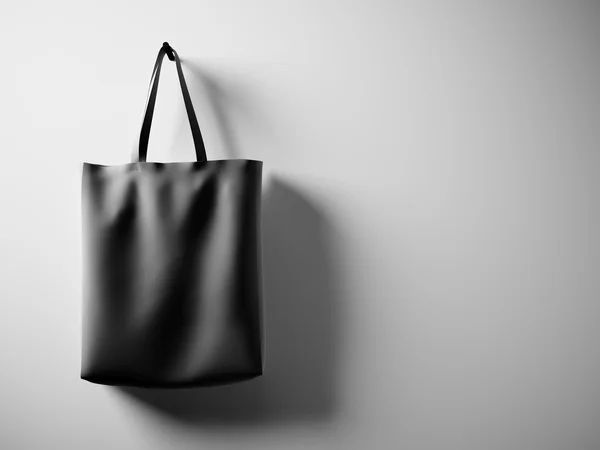 Photo black cotton textile bag hanging left side. Empty white wall background. Highly detailed texture, space for business message.  Horizontal. 3D rendering — Stock Photo, Image