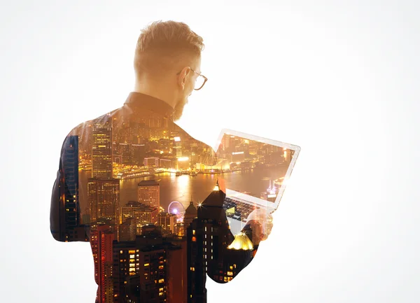 Double exposure  young bearded businessman wearing black shirt and holding contemporary notebook hands. Isolated white, night city background. Horizontal mockup — Stock Photo, Image