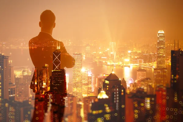 Photo of stylish adult businessman wearing trendy suit and looking night city. Double exposure, panoramic view contemporary City background. Horizontal, bokeh, blurred — Stock Photo, Image
