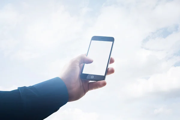 Double exposure photo businessman holding modern smartphone hand, touching empty white screen. Clouds background, ready for your business information. Horizontal mockup. Film effect — Stock Photo, Image