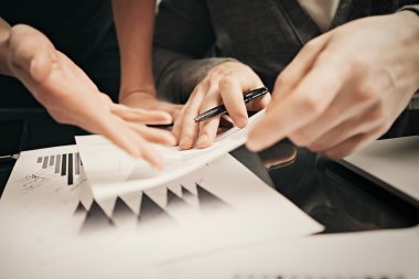 Business situation,signs reports. Photo female hand showing document. Man holding report and using pen. Working process modern office,discussion startup,finance analyze. Horizontal. Film effect