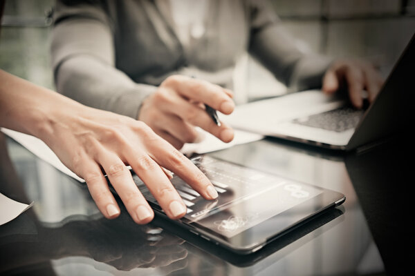 Finance department working process.Photo woman showing business reports modern tablet. Banker holding pen for signs documents, discussion startup idea.Horizontal. Film effect