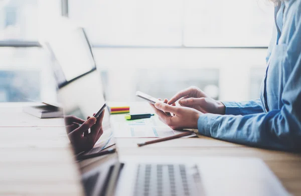 Working process photo. Account manager working wood table with new business project. Typing contemporary smartphone screen. Modern notebook reflections screen.Horizontal.Film effect,blurred — Stock fotografie