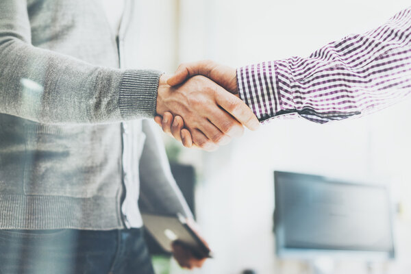 Business partnership meeting. Photo businessmans handshake. Successful businessmen handshaking after good deal. Horizontal, blurred background