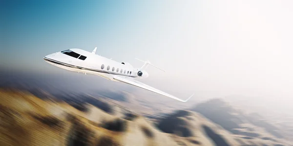 Image of white modern and luxury generic design private jet flying at sunrise over uninhabited desert.Mountains background.Business travel concept. Horizontal,motion blurred effect. 3d rendering — Stock Photo, Image