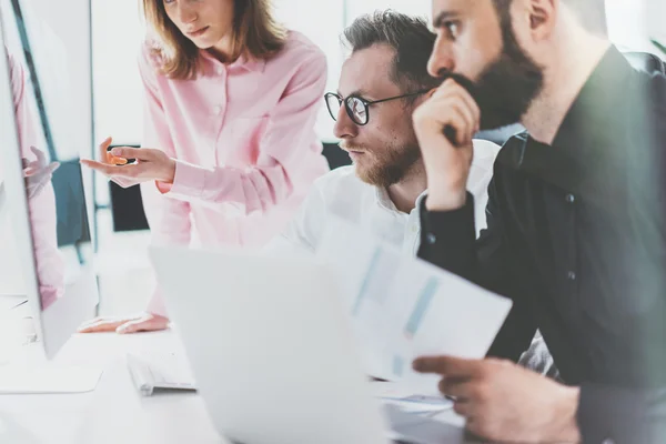 Fotky pro spolupracovníky v prosluněné kanceláři. Tým vedoucích projektů pracuje na nové myšlence. Mladí obchodní lidé diskutují o startu moderního studia. Stolní počítač v tabulce, zobrazení prezentace. Rozmazané, filmový efekt. Vodorovné — Stock fotografie