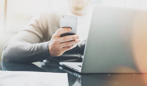 Working process image. Manager working table with new startup project. Modern notebook table. Using contemporary smartphone. Horizontal. Flares, film effect. Blurred background — Stock Photo, Image