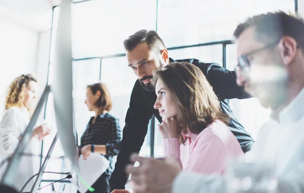 Young professionals work in modern office.Project manager team discussing new idea.Business crew working with startup.Modern desktop computer table,showing presentation.Blurred,film effect. — Stock Photo, Image