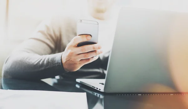 Working process image. Manager working table with new startup project. Modern notebook table. Using contemporary smartphone. Horizontal. Visual and film effect. Blurred background — Stock Photo, Image