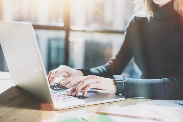 Work Process in Modern Office. Young Account Manager Working at Wood Table with New Business Project.Typing Contemporary Laptop keyboard,Wearing Smartwatch. Horizontal. Film effect. Blurred background — Stock Photo, Image