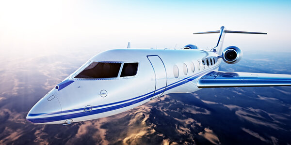 Image of White Luxury Generic Design Private Jet Flying in Blue Sky at sunset.Uninhabited Desert Mountains Background.Business Travel Picture.Horizontal,Film Effect. 3D rendering.