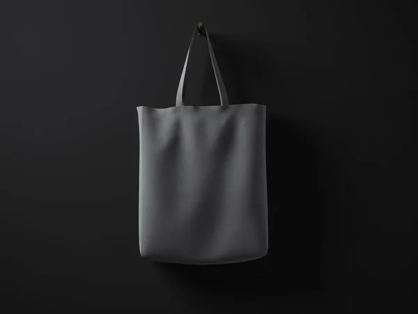 Photo dark gray cotton textile material bag hanging in center. Empty concrete black painted wall background. Highly detailed texture, space for your business message. Horizontal mockup. 3D rendering — Stock Photo, Image