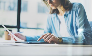 Work process modern Studio Loft.Art director woman working wood table with new freelance business startup. Using Digital Tablet,Touching Screen. Horizontal.Film effect. Blurred background