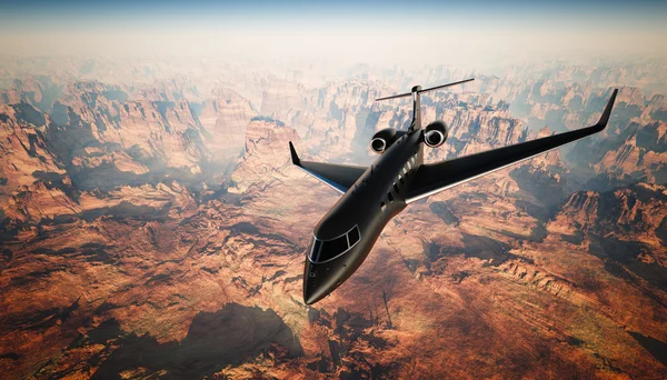 Foto Black Matte Luxury Generic Design Private Jet Volare in cielo sotto la superficie terrestre. Sfondo del Grand Canyon. Foto di viaggio d'affari.Orizzontale, anteriore vista angolo superiore. Effetto pellicola. Rendering 3D . — Foto Stock