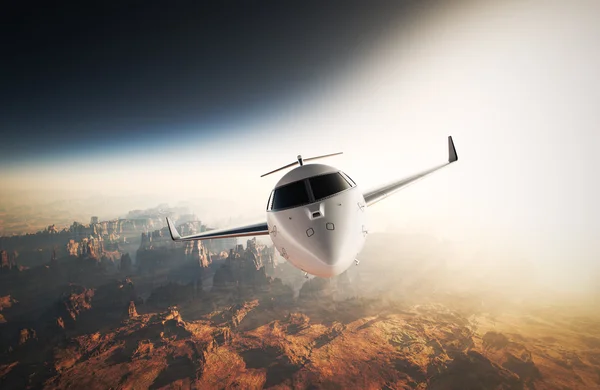 Foto Bianco lucido Design generico Private Jet Volare in cielo sotto la superficie della terra.Grand Canyon sfondo Tramonto. Foto di viaggio d'affari.Orizzontale, Vista anteriore.Effetto pellicola. Rendering 3D . — Foto Stock