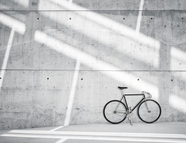 Horizontal Photo Blank Grungy Smooth Bare Concrete Wall in Modern Loft Studio with Classic bike. Soft Sunrays Reflecting on Surface. Empty Abstract background.