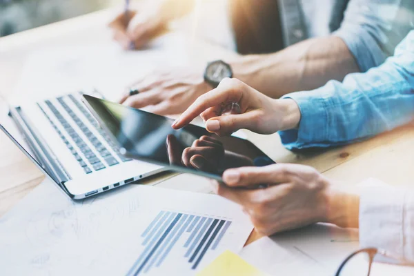 Coworkers team brainstorm in modern office.Project Manager Researching Process,Touching Screen Digital Tablet.Young Business Crew Working with Startup Studio.Graphics,reports wood Table.Closeup Photo. — Stock Photo, Image