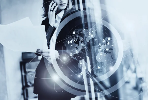 Photo business woman wearing black suit,talking smartphone, holding papers hands.Open space loft office.Panoramic windows background.Connections world wide interfaces.Horizontal,black and white. — Stock Photo, Image