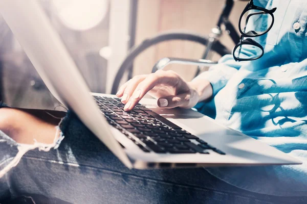 Work process modern Studio Loft.Creative Producer working coworkers office with new freelance business startup.Using Laptop on knees, holding glasses hand.Horizontal closeup.Flares Efft.Blurred . — стоковое фото