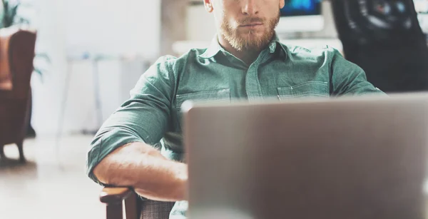 Bearded Businessman working Laptop modern Interior Design Loft Studio Office.Man relaxing Vintage chair.Use contemporary Notebook, blurred background.Creative Process New Startup Idea.Wide,film eff — Stock Photo, Image