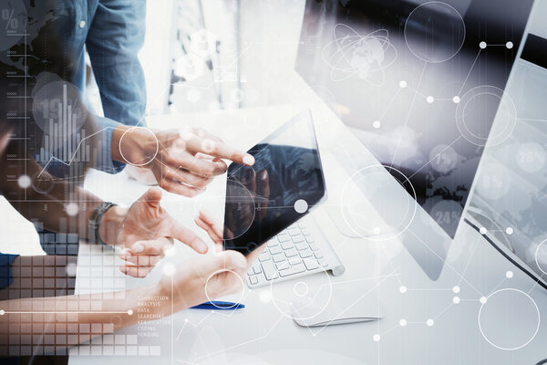 Coworkers Team Working Office Studio Startup.Businessman Using Modern Tablet, Desktop Monitor Wood Table.Bank Managers Market Researching Process.World Wide HiTech Icons Interface Screen Device Blurred
