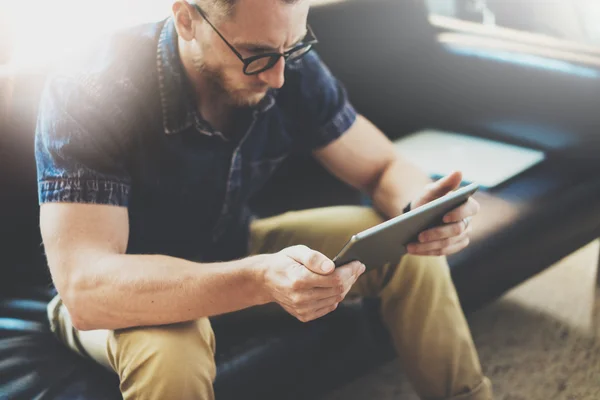 Bearded Banker working tablet computer modern Interior Design Loft Building.Man relax Vintage sofa use contemporary device Hand.Blurred background.Creative business startup Idea.Horizontal, Film effec — стоковое фото