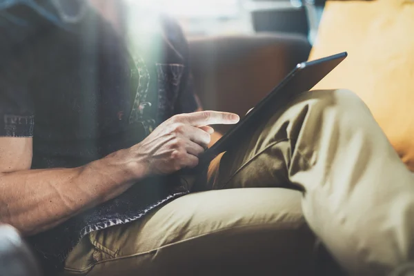 Successful Trade Manager reading business news modern Interior Design Loft Office.Man relax Vintage Sofa,Use contemporary tablet,share information.Blurred Background.New Startup Idea Process.Closeup. — Stock Photo, Image