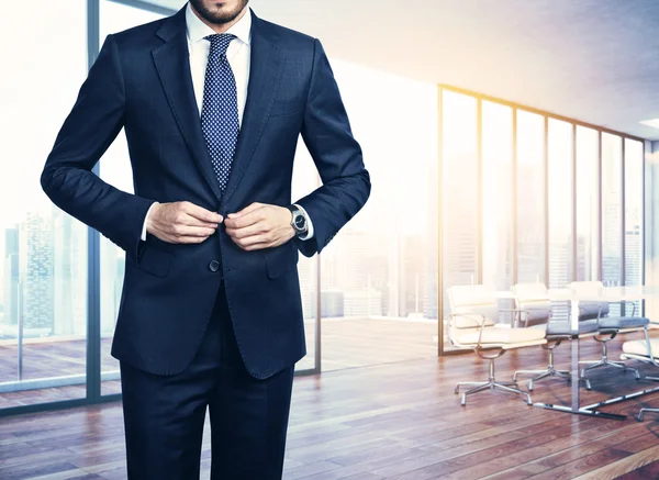 Young businessman and office interior — Stock Photo, Image