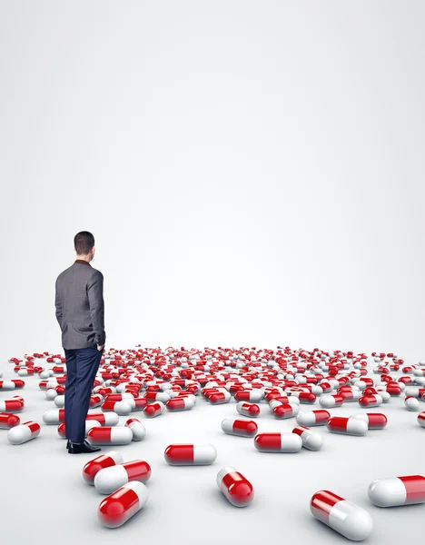 Man standing among pills — Stock Photo, Image