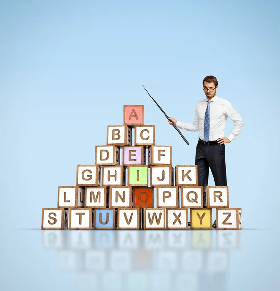 Teacher and colorful letter blocks — Stock Photo, Image